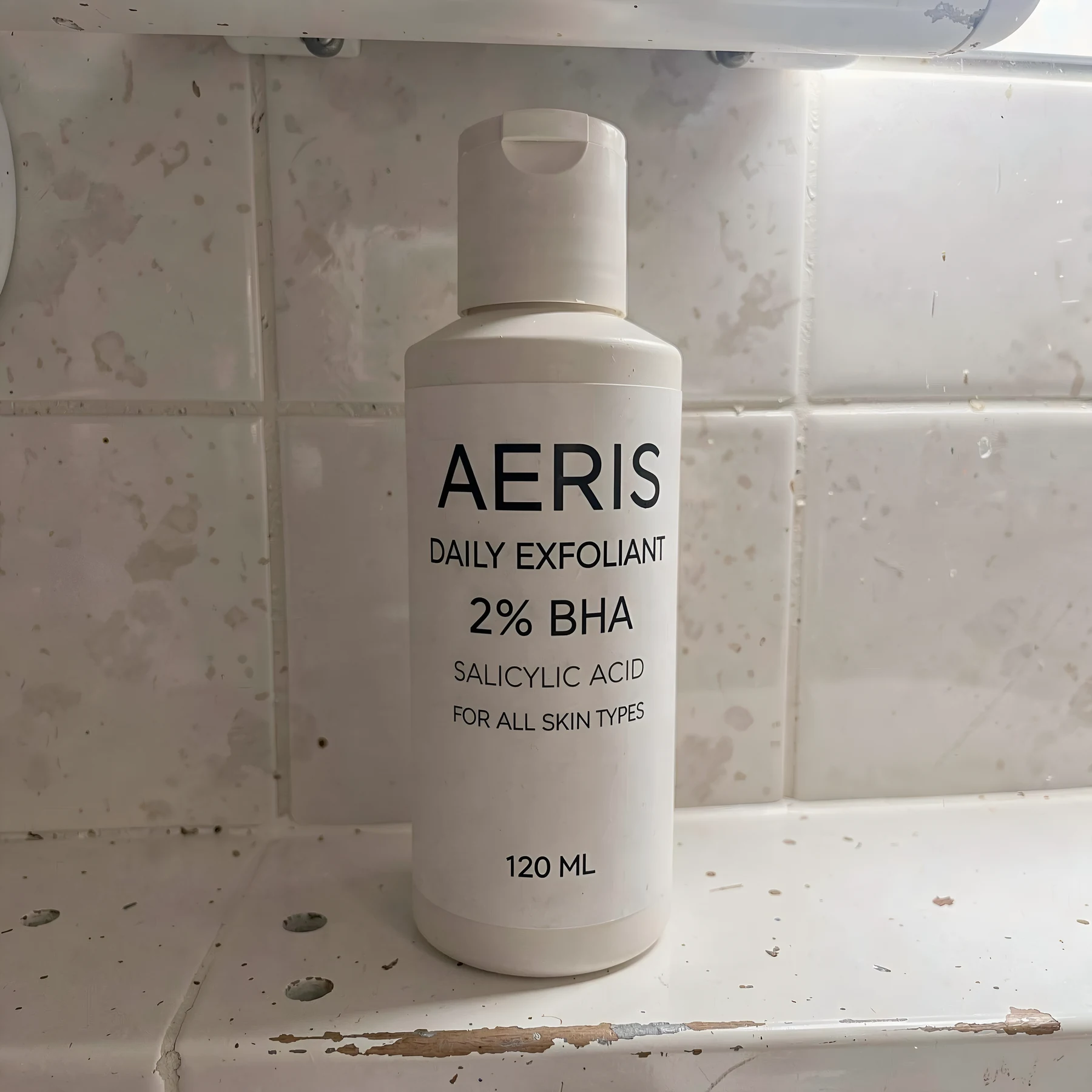 Original amateur smartphone photo of the AERIS exfoliant bottle